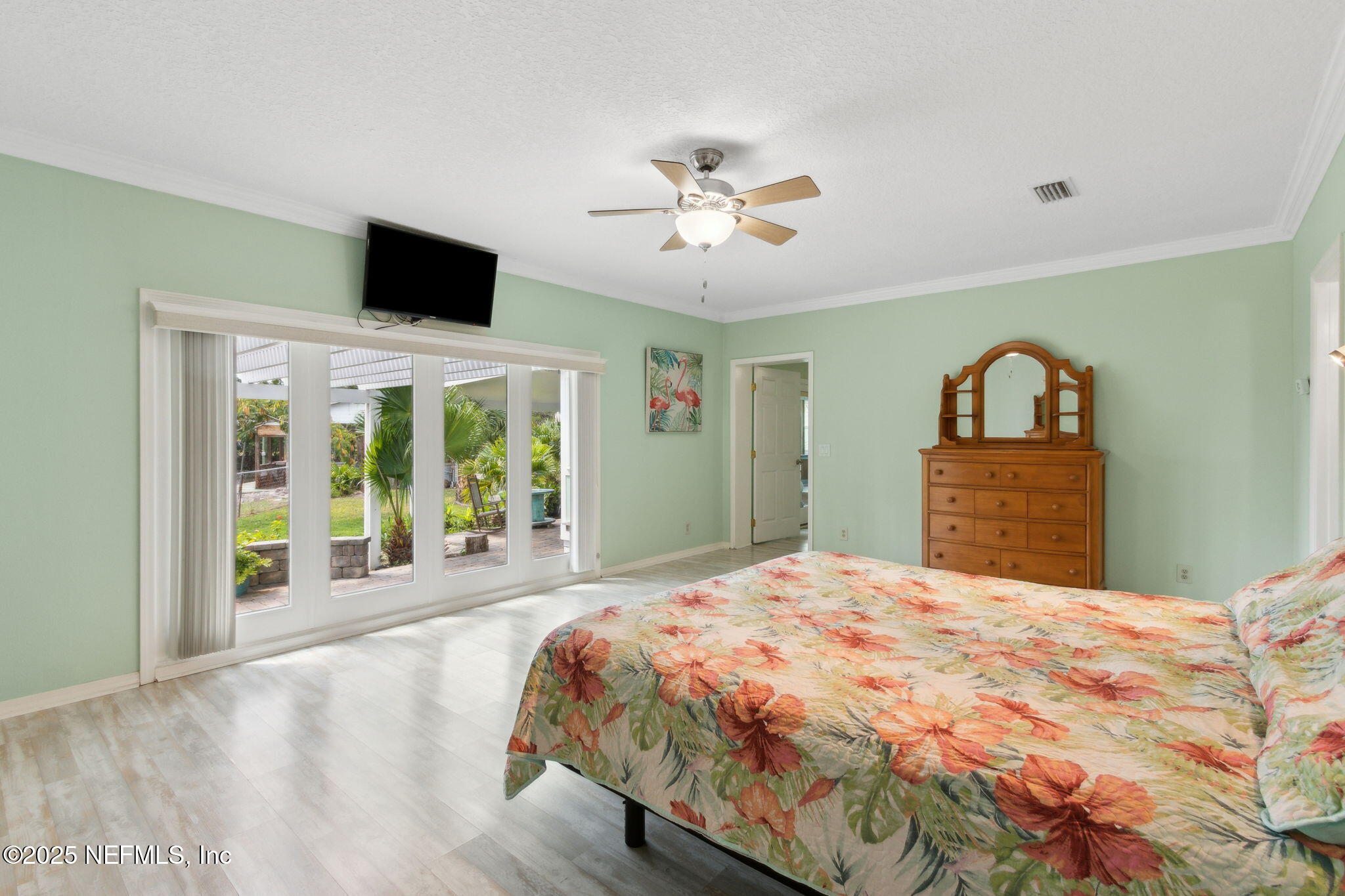 16062 Shark Road West Jacksonville, FL 32226 - Photo 13 of 43 a bedroom with a large bed and a large window