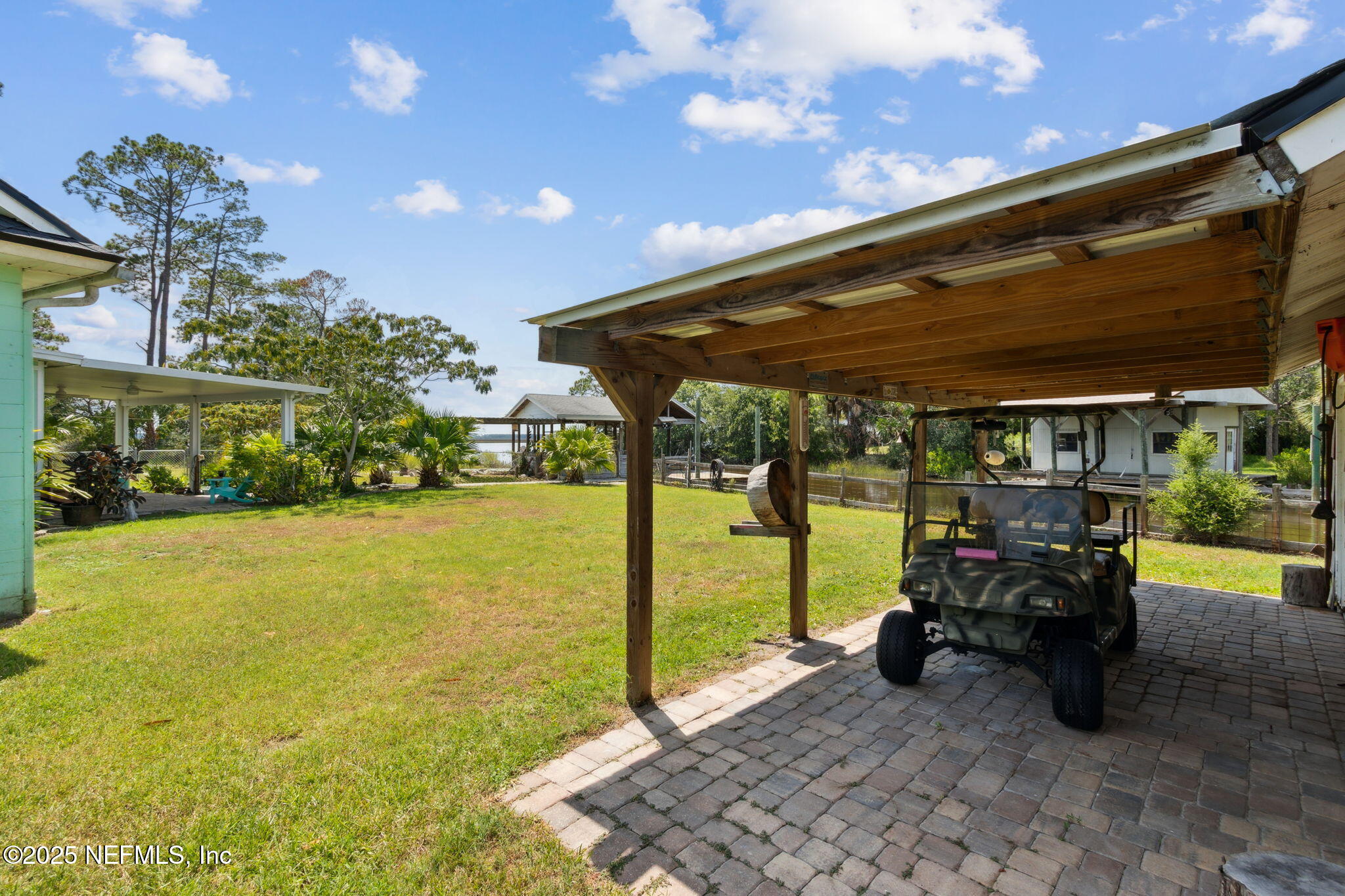 16062 Shark Road West Jacksonville, FL 32226 - Photo 28 of 43 a view of a patio with table and chairs under an umbrella with a patio
