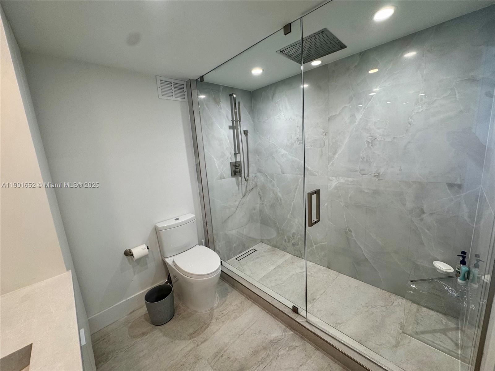 2899 Collins Avenue, Unit 1414 Miami Beach, FL 33140 - Photo 4 of 26 a bathroom with a shower and toilet