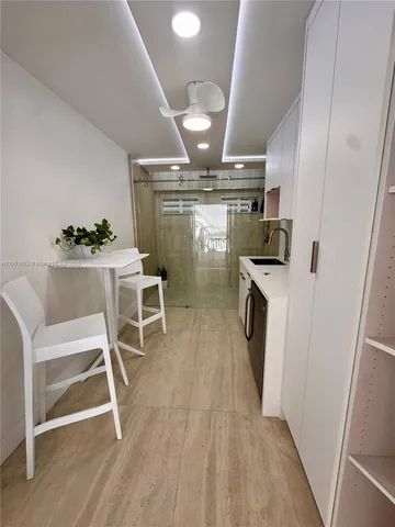a room with wooden floors and white walls