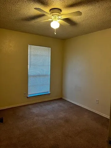 a view of empty room with a fan