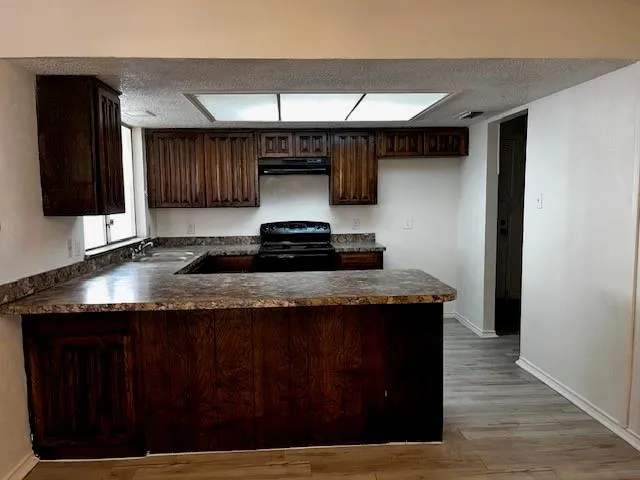 a kitchen with stainless steel appliances granite countertop a stove and a refrigerator