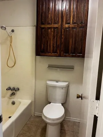 a bathroom with a toilet a sink and bathtub