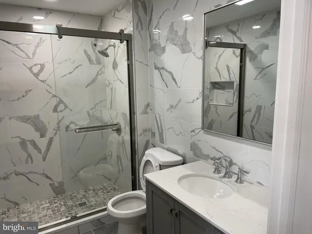 a bathroom with a sink toilet and shower