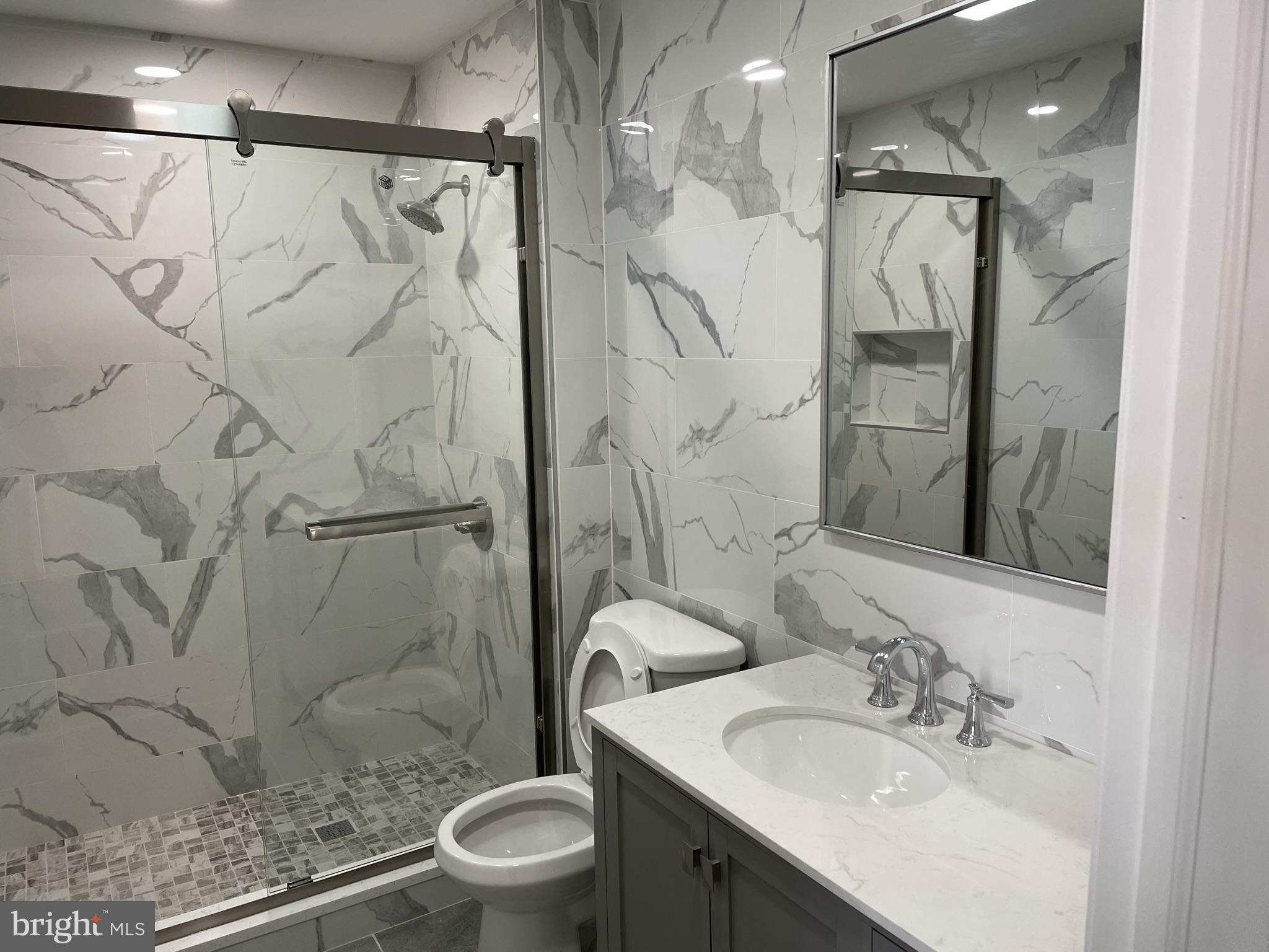 910 Arch Street, Unit 2F Philadelphia, PA 19107 - Photo 1 of 18 a bathroom with a sink toilet and shower