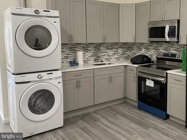 a utility room with sink dryer and washer