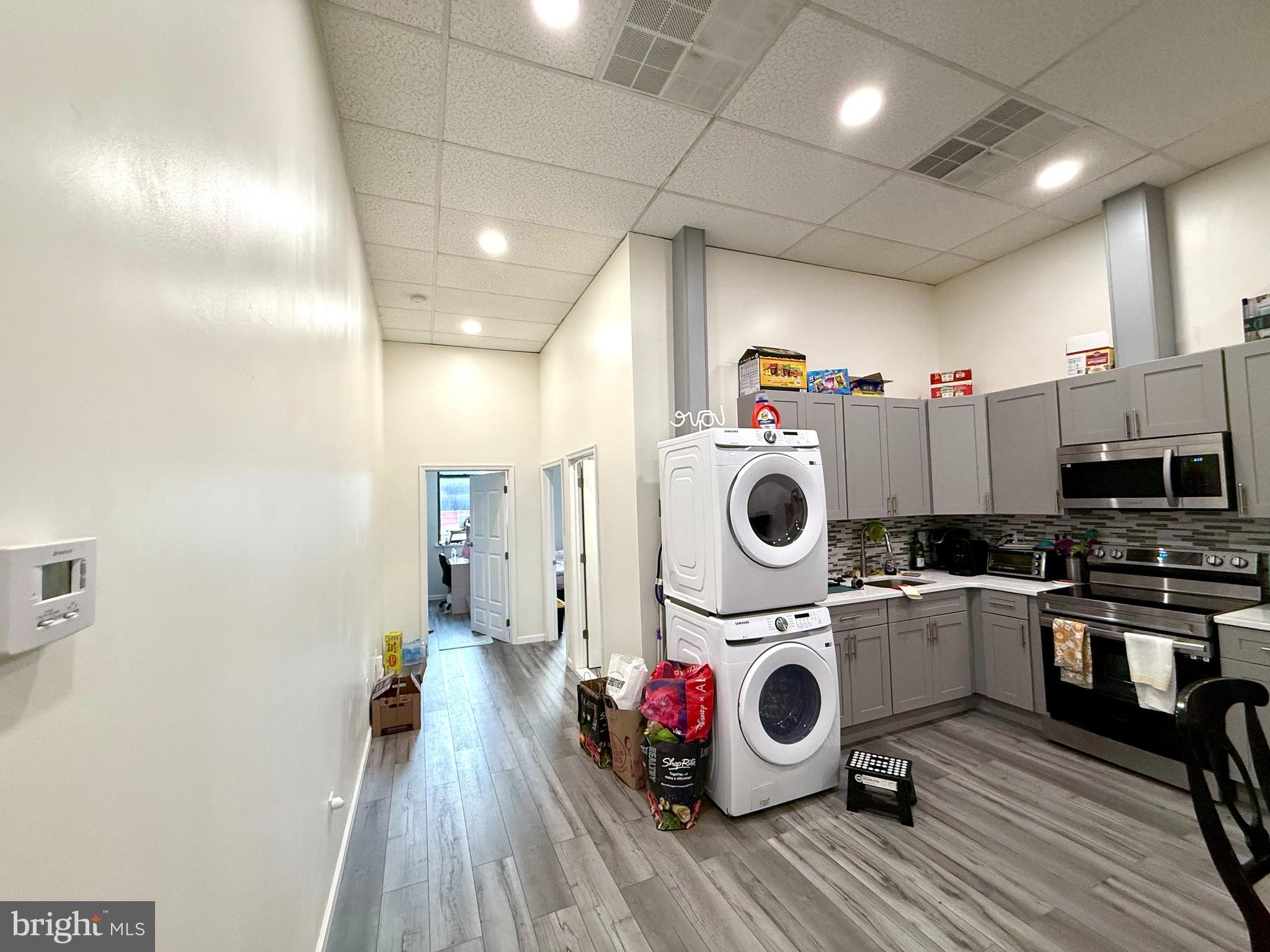 910 Arch Street, Unit 2F Philadelphia, PA 19107 - Photo 13 of 18 a utility room with sink dryer and washer