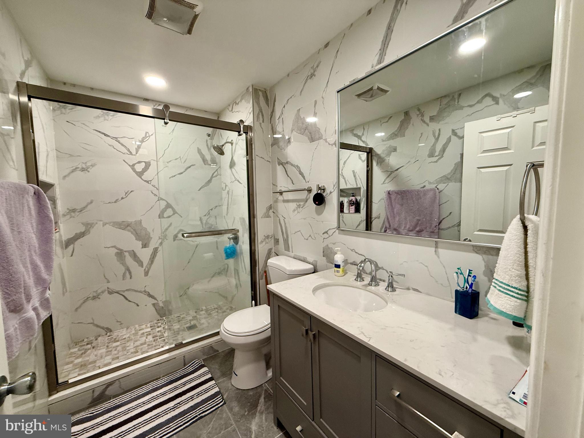 910 Arch Street, Unit 2F Philadelphia, PA 19107 - Photo 14 of 18 a bathroom with a sink a toilet and shower