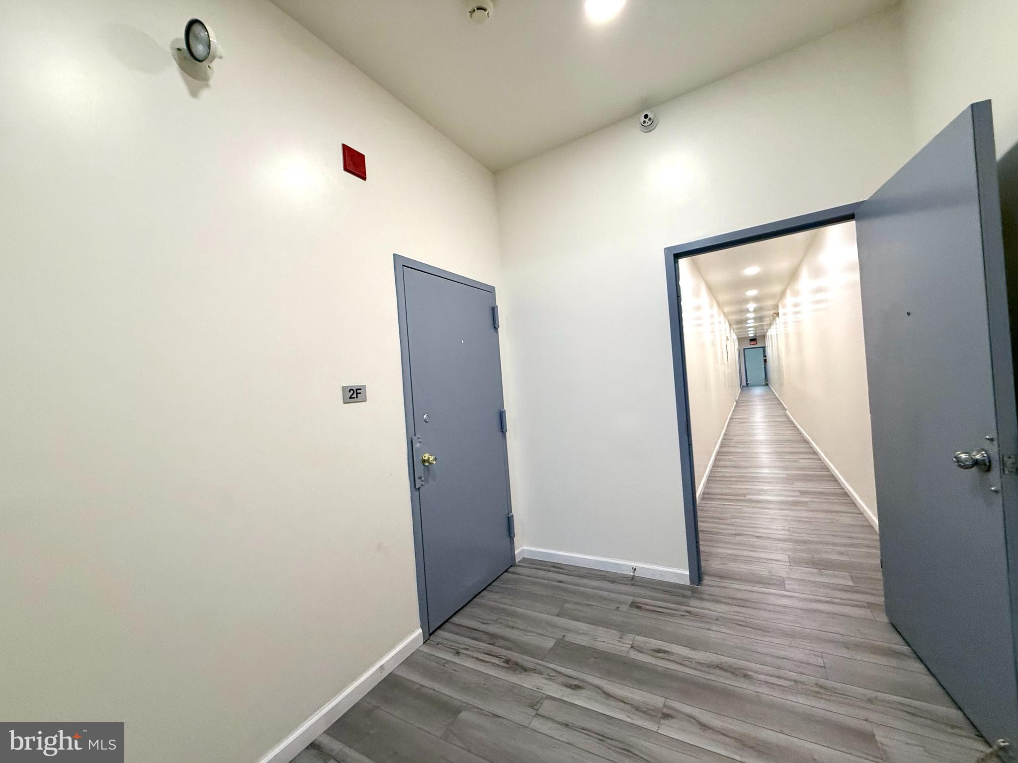 910 Arch Street, Unit 2F Philadelphia, PA 19107 - Photo 15 of 18 a view of a hallway with wooden floor