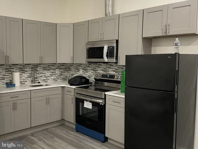 a kitchen with stainless steel appliances granite countertop a refrigerator stove a sink and dishwasher