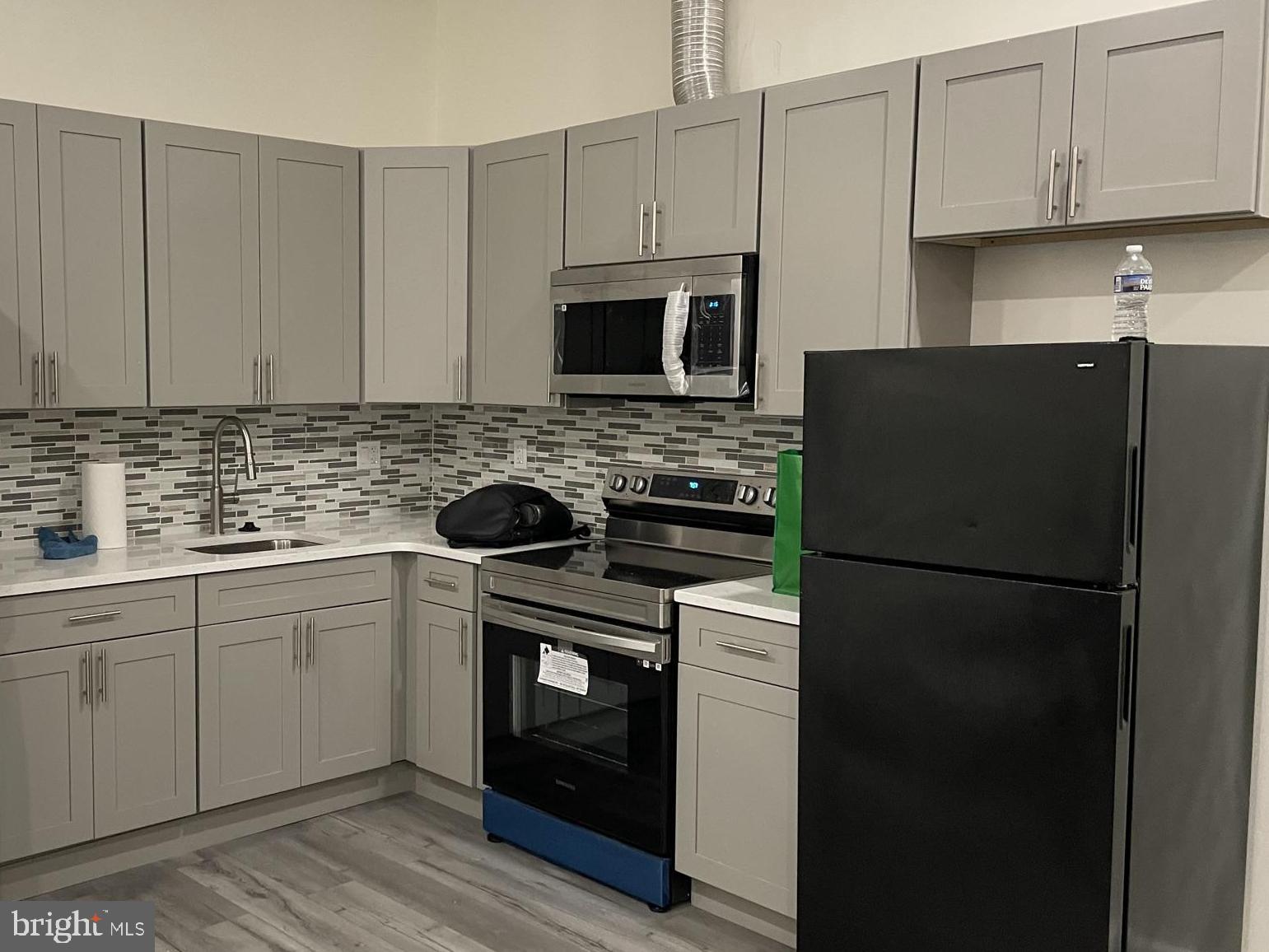 910 Arch Street, Unit 2F Philadelphia, PA 19107 - Photo 2 of 18 a kitchen with stainless steel appliances granite countertop a refrigerator stove a sink and dishwasher