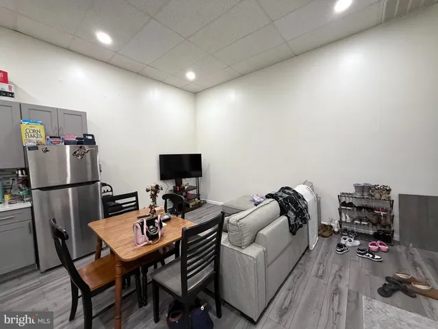 a view of a small space with wooden floor and a window