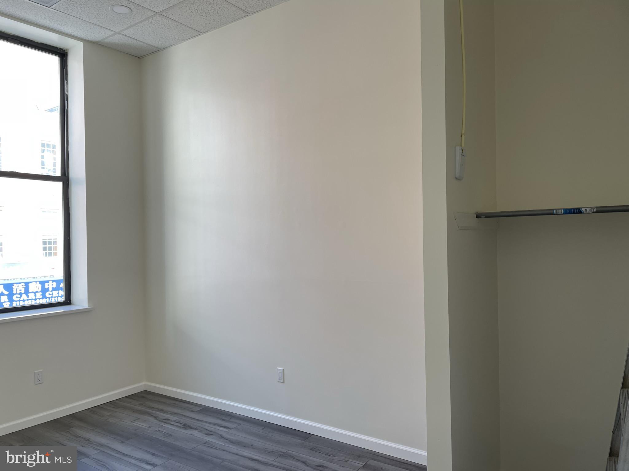 910 Arch Street, Unit 2F Philadelphia, PA 19107 - Photo 6 of 18 a view of a small space with wooden floor and a window