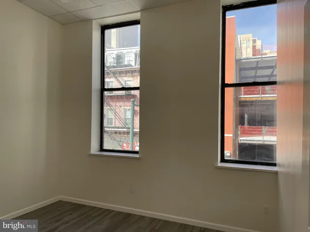 a bedroom with furniture and a wooden floor