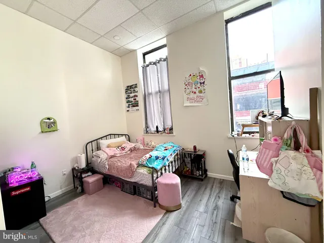 a bedroom with a bed and a dresser