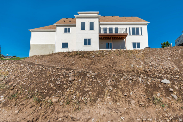 1351 Maple Circle Santaquin, UT 84655 - Photo 41 of 42 Contemporary residence featuring a white stucco exterior, multiple window styles, and a second-story balcony with a dark railing