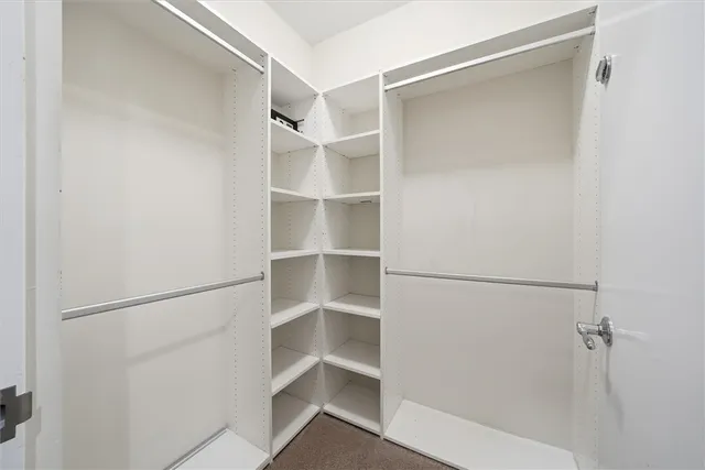 a white house with green field in front of it