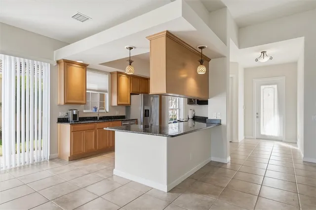 a view of a kitchen with furniture and a ceiling fan