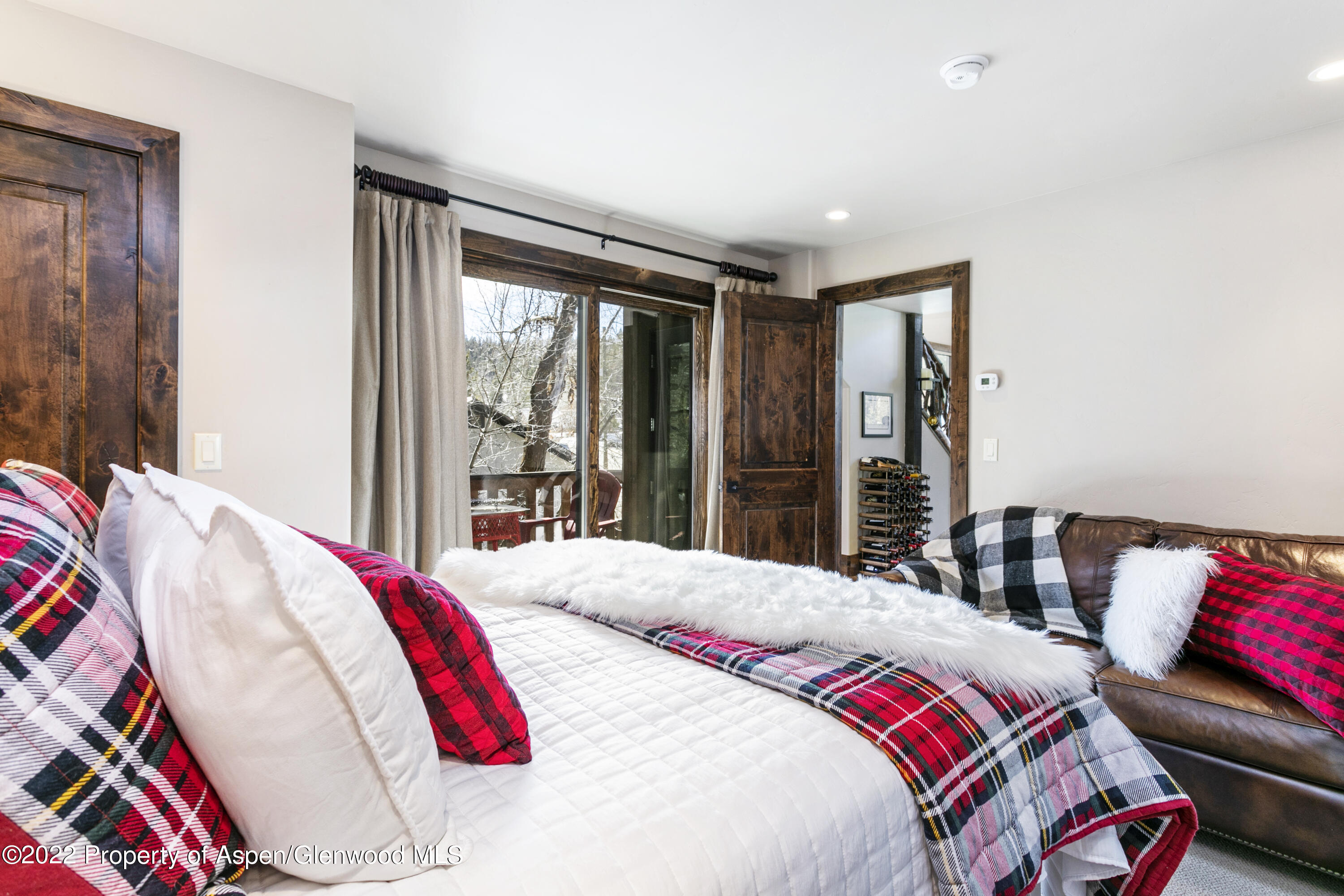 850 Main Street, Unit B Minturn, CO 81645 - Photo 12 of 24 a bedroom with a bed and a large mirror next to a window