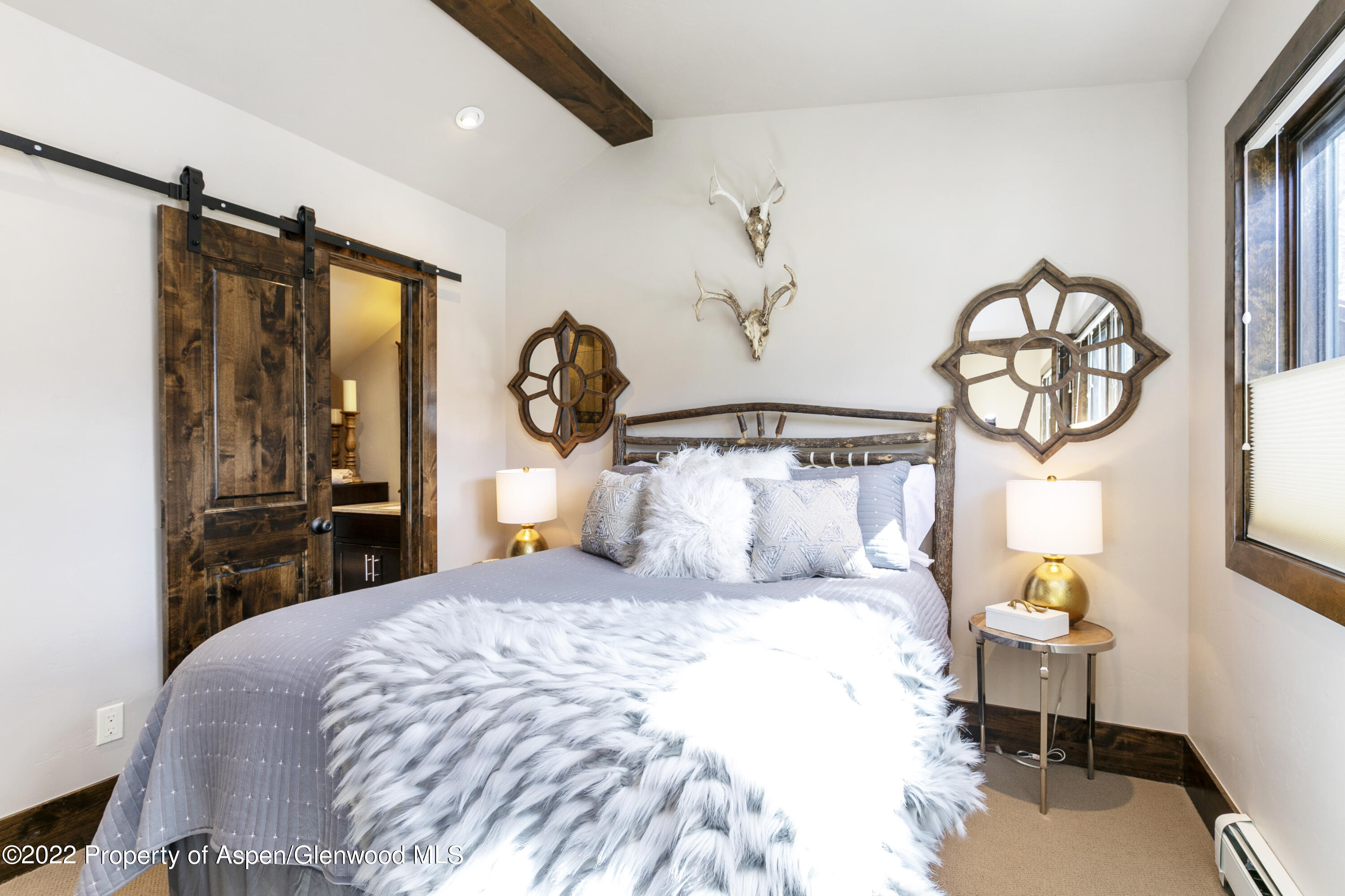 850 Main Street, Unit B Minturn, CO 81645 - Photo 15 of 24 a bedroom with a large bed and a chandelier