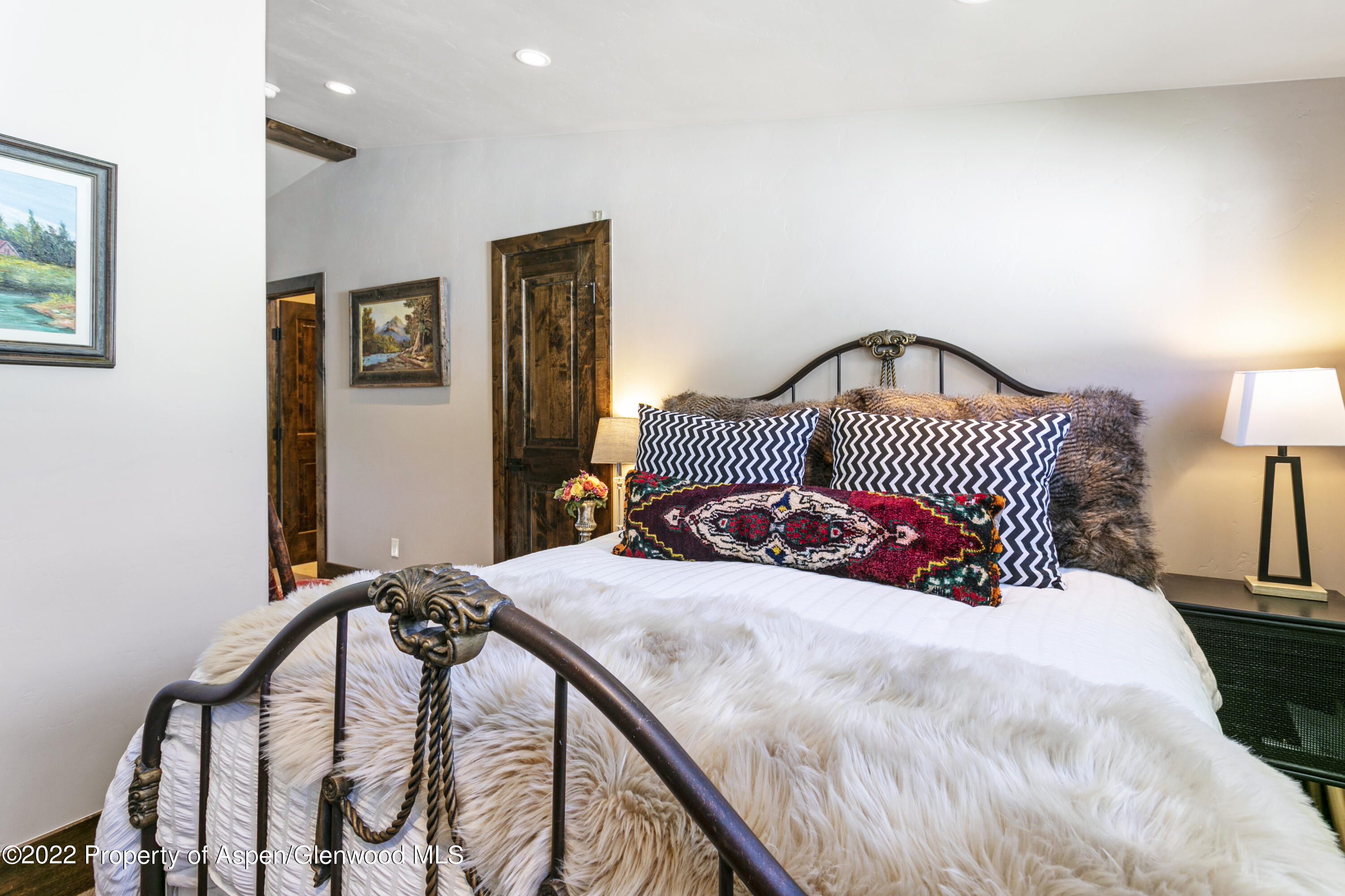 850 Main Street, Unit B Minturn, CO 81645 - Photo 20 of 24 a bedroom with a bed and a lamp