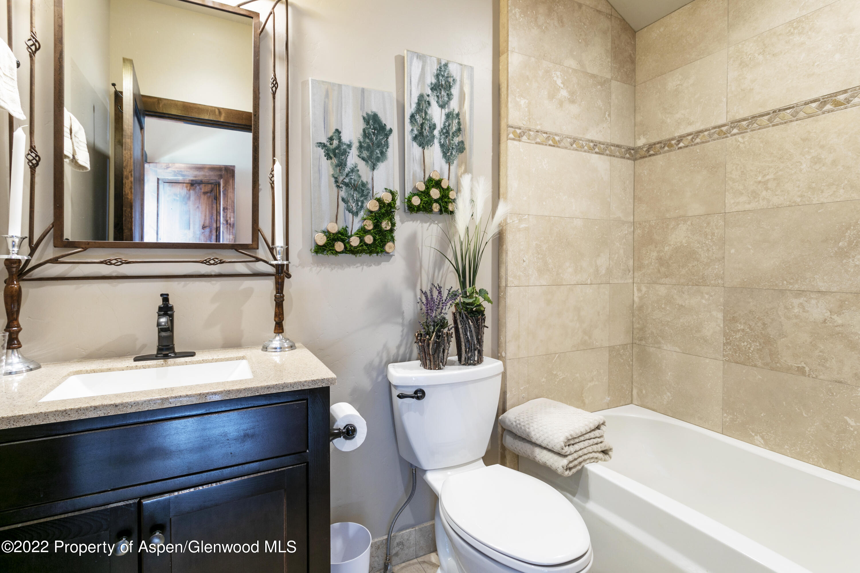 850 Main Street, Unit B Minturn, CO 81645 - Photo 21 of 24 a bathroom with a sink a toilet a mirror and shower