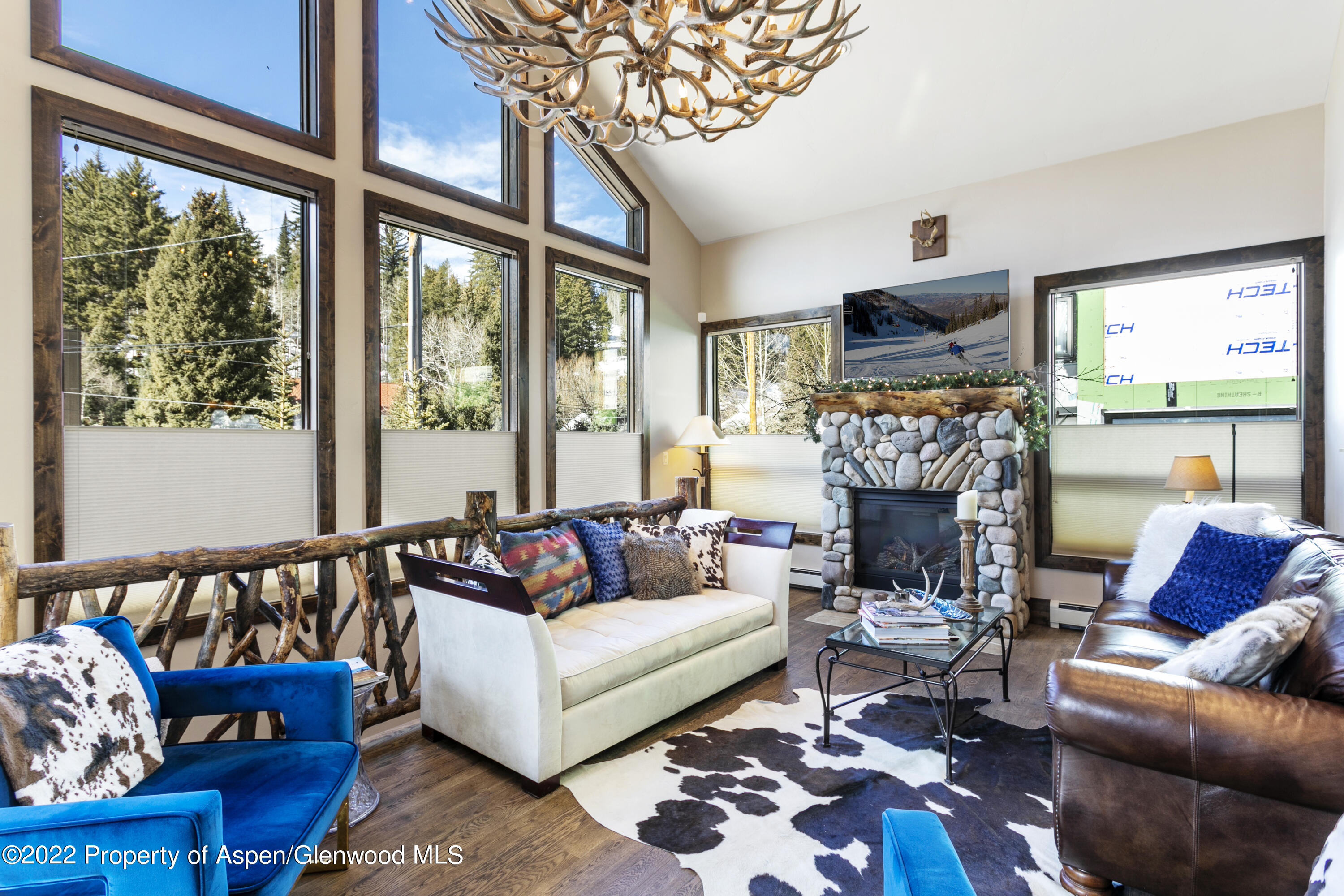 850 Main Street, Unit B Minturn, CO 81645 - Photo 4 of 24 a living room with furniture a fireplace and a flat screen tv