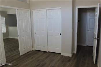 13402 East Boston Street Chandler, AZ 85225 - Photo 13 of 19 a view of an empty room with wooden floor