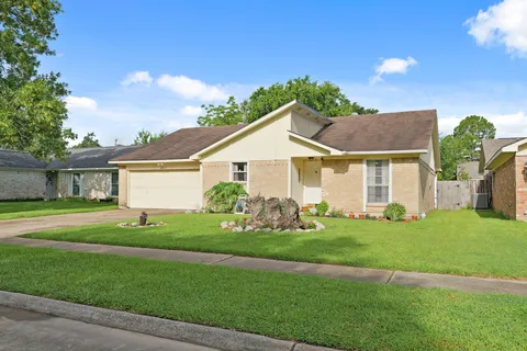 a front view of a house with a garden and yard