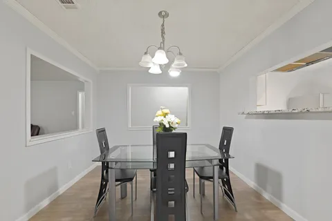 a dining room with furniture and chandelier