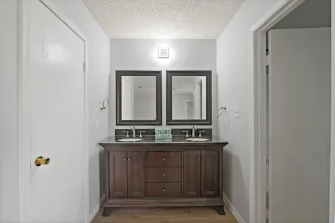 a bathroom with a double vanity sink and mirror