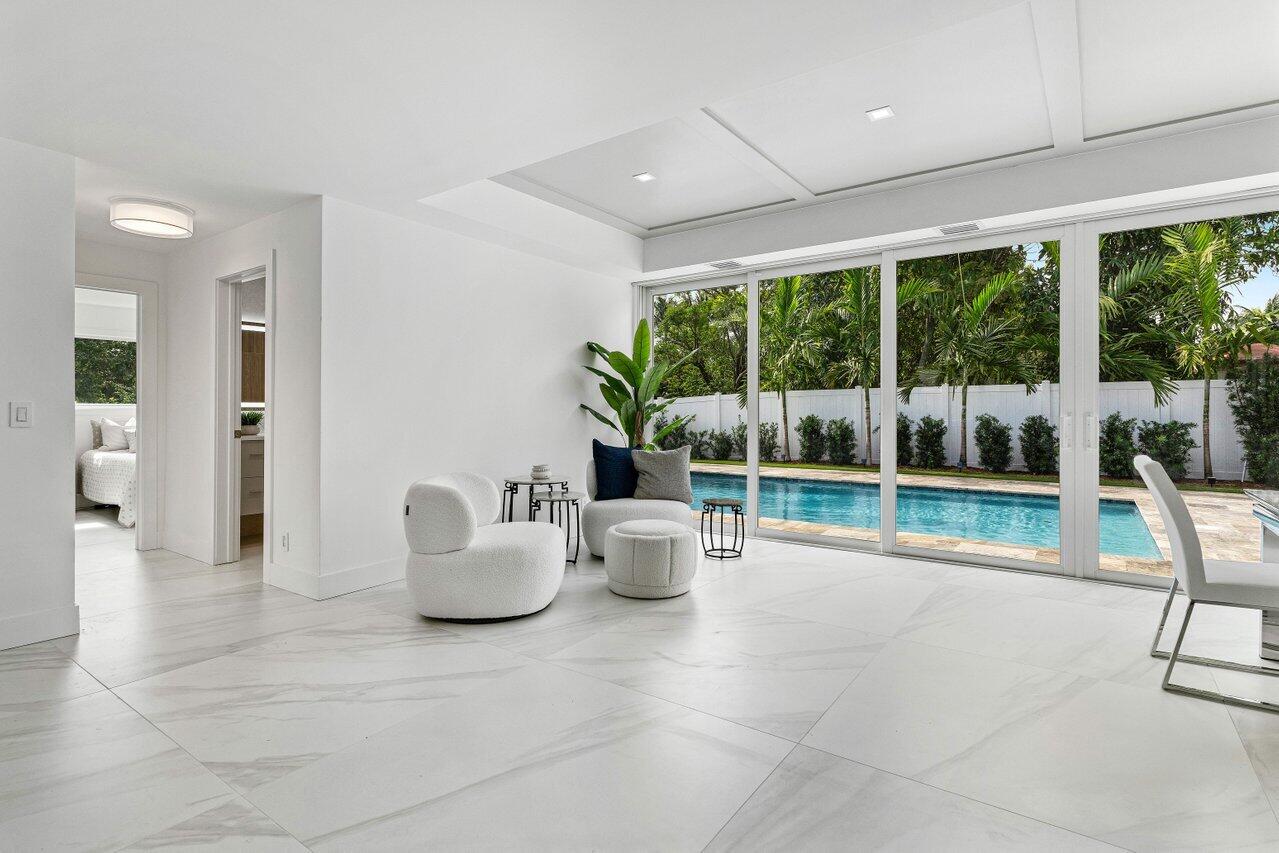 902 Southwest 27th Place Boynton Beach, FL 33435 - Photo 12 of 52 a living room with furniture and a floor to ceiling window