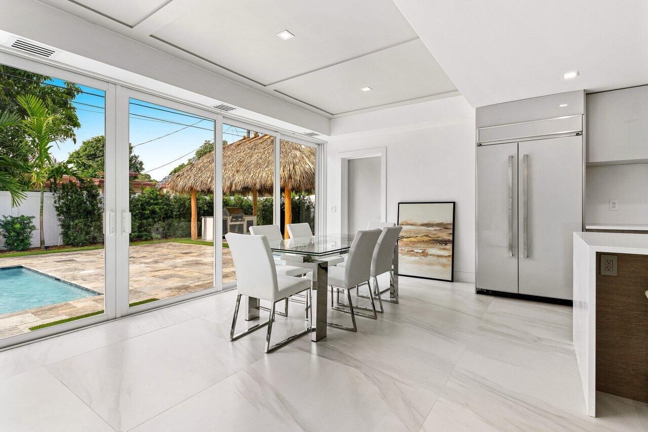 902 Southwest 27th Place Boynton Beach, FL 33435 - Photo 14 of 52 a dining room with furniture and a floor to ceiling window