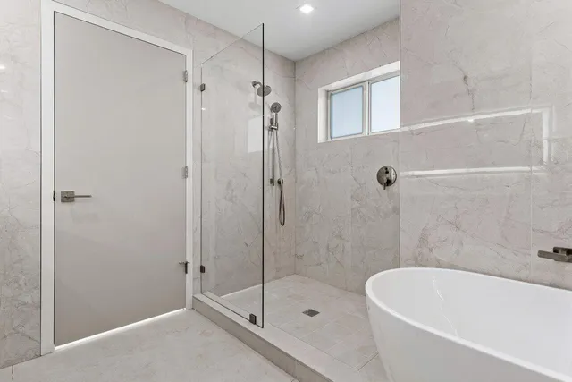 a bathroom with a shower sink vanity and toilet