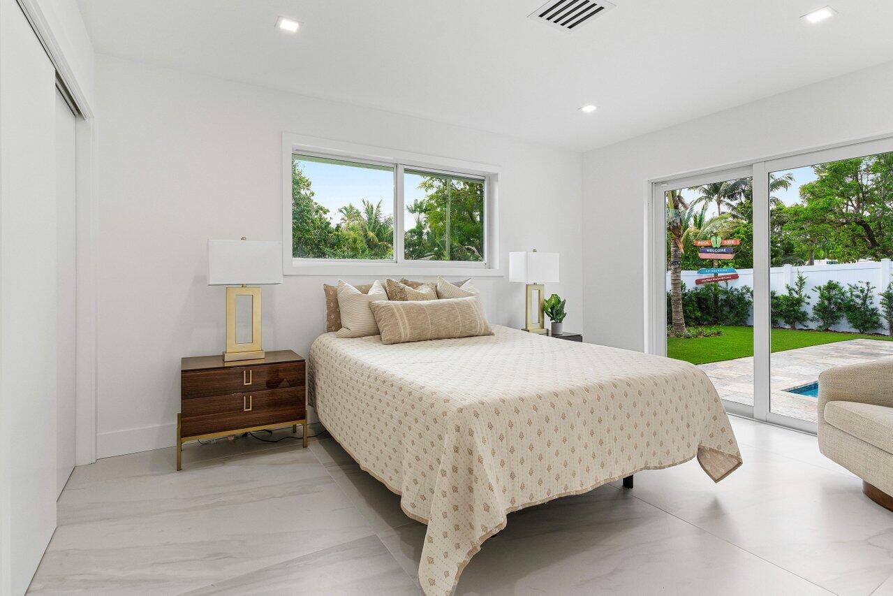 902 Southwest 27th Place Boynton Beach, FL 33435 - Photo 21 of 52 a bed sitting in a spacious bedroom next to a window