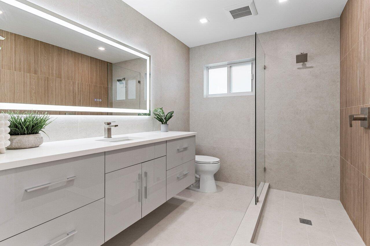 902 Southwest 27th Place Boynton Beach, FL 33435 - Photo 23 of 52 a bathroom with a sink a toilet and shower