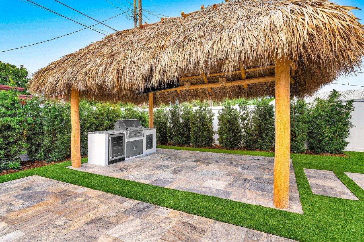 902 Southwest 27th Place Boynton Beach, FL 33435 - Photo 26 of 52 a view of a white house with a yard