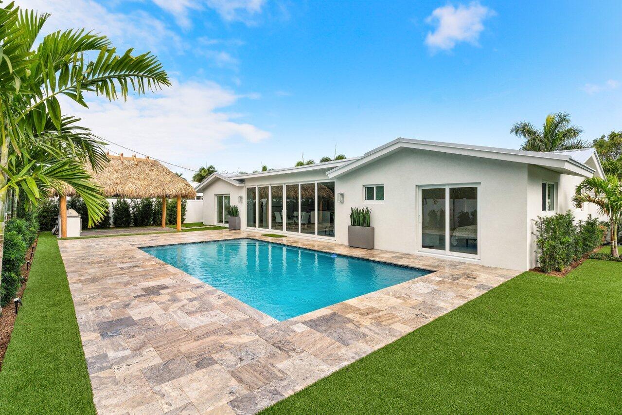 902 Southwest 27th Place Boynton Beach, FL 33435 - Photo 30 of 52 a view of a house with a swimming pool