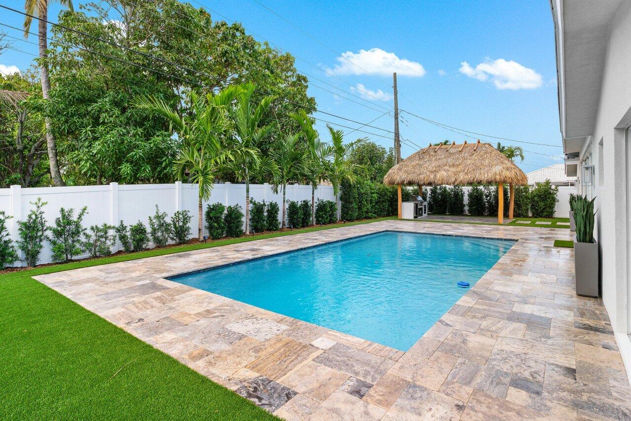 902 Southwest 27th Place Boynton Beach, FL 33435 - Photo 31 of 52 a view of a swimming pool with a patio