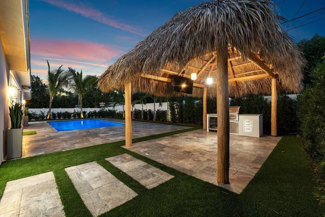 a view of a house with backyard and swimming pool