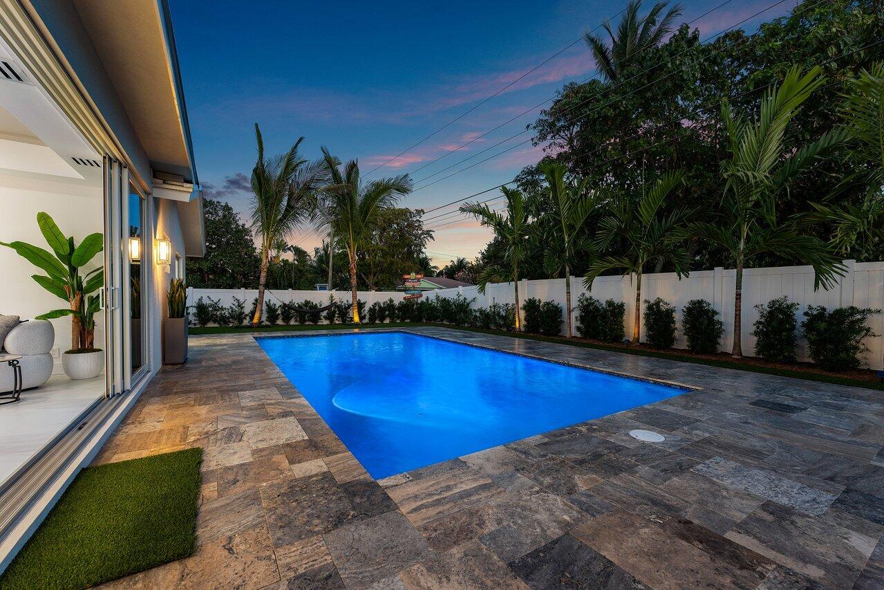 902 Southwest 27th Place Boynton Beach, FL 33435 - Photo 36 of 52 a swimming pool with outdoor seating and yard