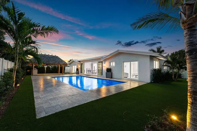 a front view of a house with a garden and yard