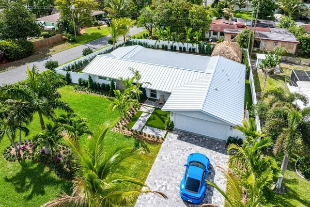 an aerial view of a house with a garden and swimming pool