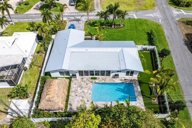 an aerial view of a house with a yard basket ball court and outdoor seating