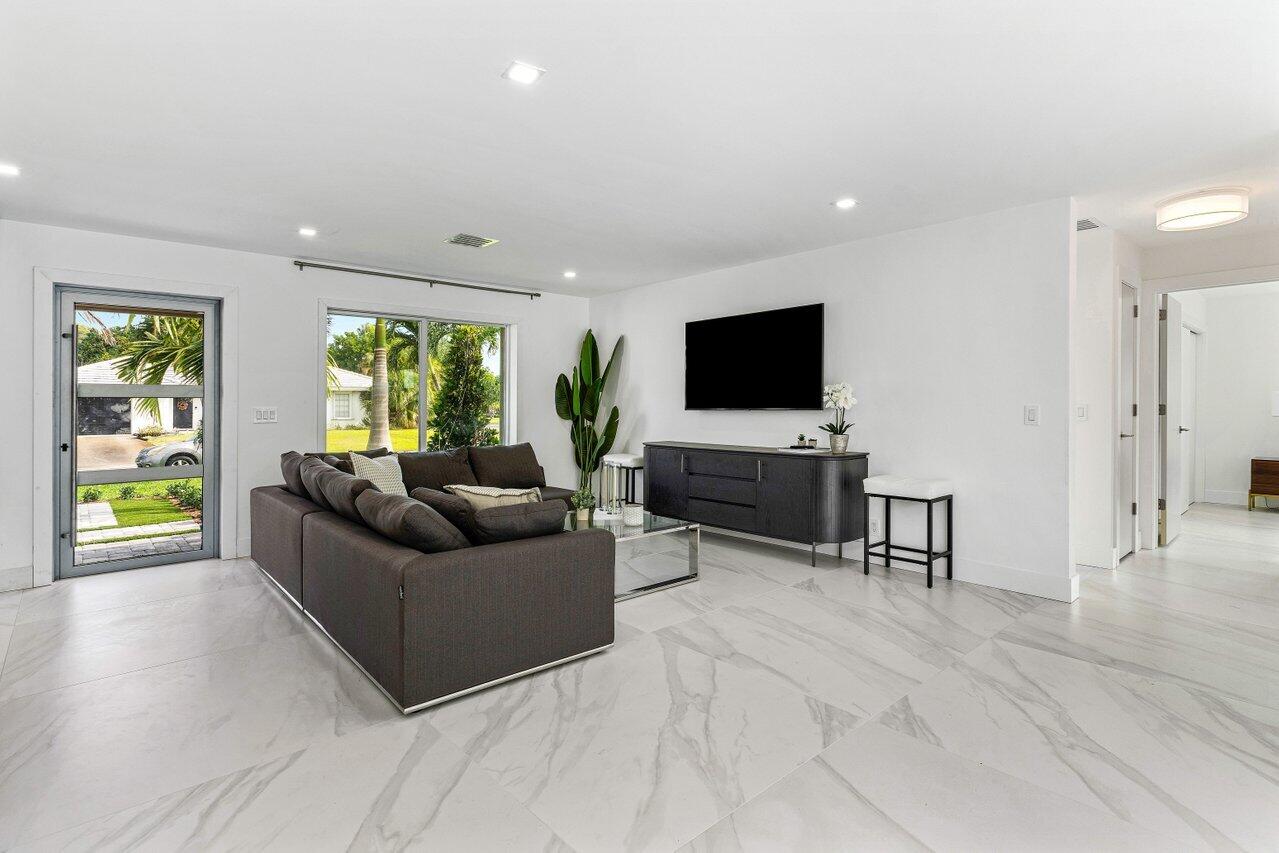 902 Southwest 27th Place Boynton Beach, FL 33435 - Photo 5 of 52 a living room with furniture and a flat screen tv