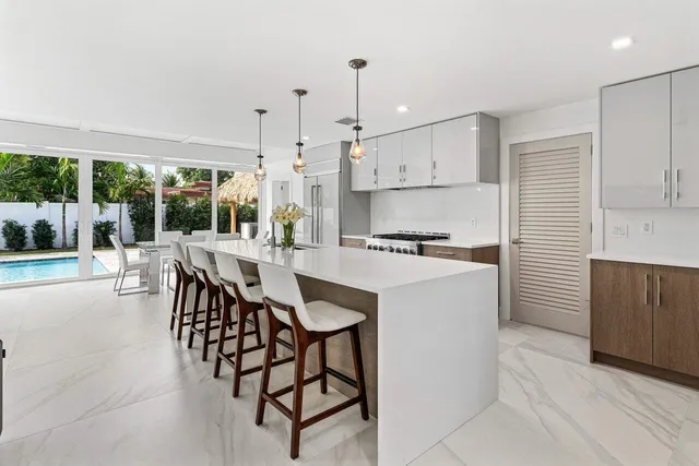 a living room with furniture a large window and a flat screen tv