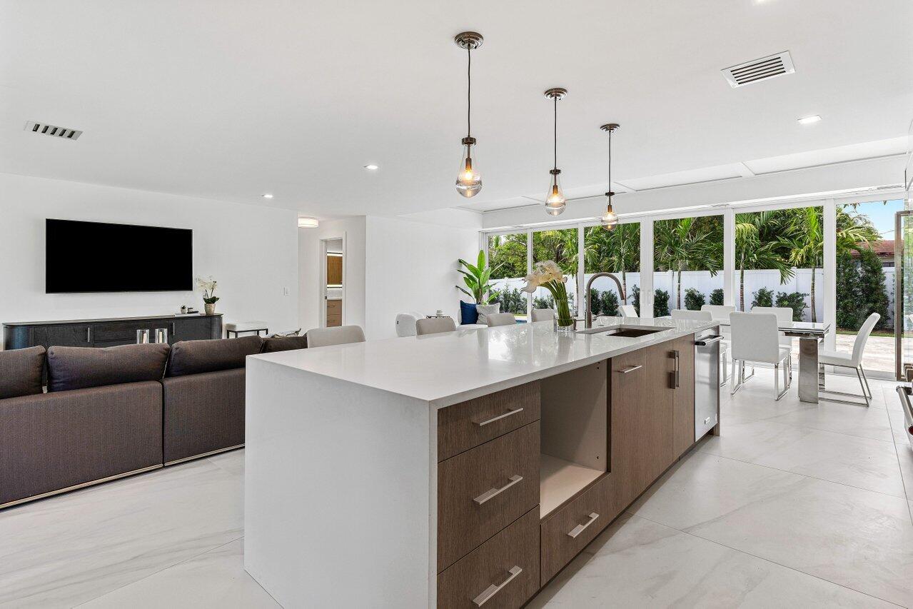 902 Southwest 27th Place Boynton Beach, FL 33435 - Photo 10 of 52 a living room with furniture a large window and a flat screen tv