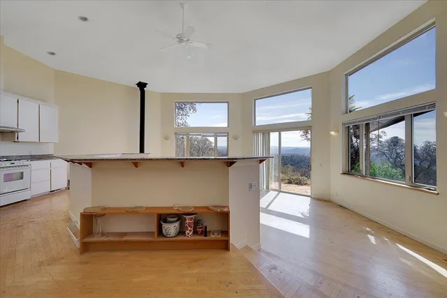 a kitchen with granite countertop a sink stove and refrigerator