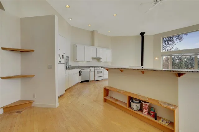 a kitchen with granite countertop a sink and cabinets