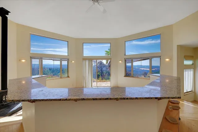 a bedroom with a balcony a bed and a painting on the wall